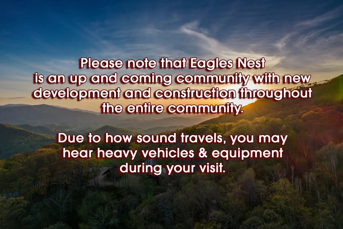 A sweeping view of the surrounding mountain range at sunset, lush greenery in the foreground, and clear skies overhead. The landscape invites exploration and highlights the natural beauty that awaits families just beyond their doorstep, ideal for hiking, photography, and connection with nature.